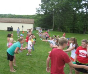 Campers doing the water balloon toss
