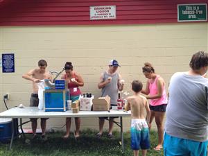 Summer Staff serving up snow cones for Campers